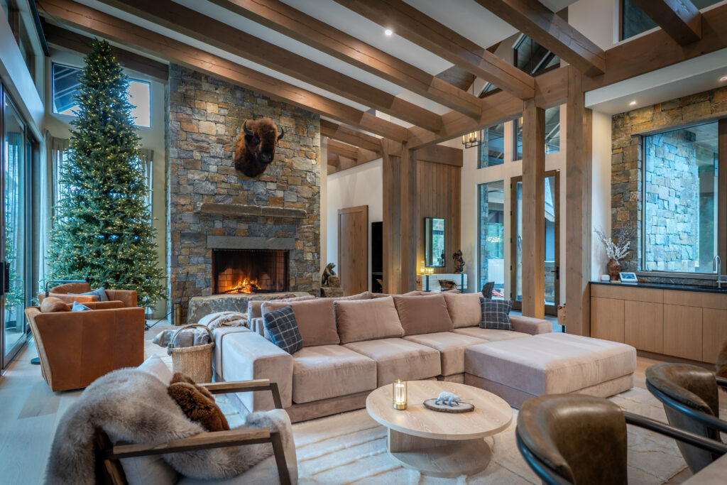 a living room with a fireplace and a couch, a luxury ski chalet in Revelstoke